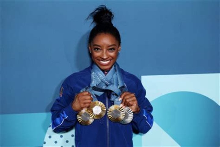 How does Simone Biles get paid?